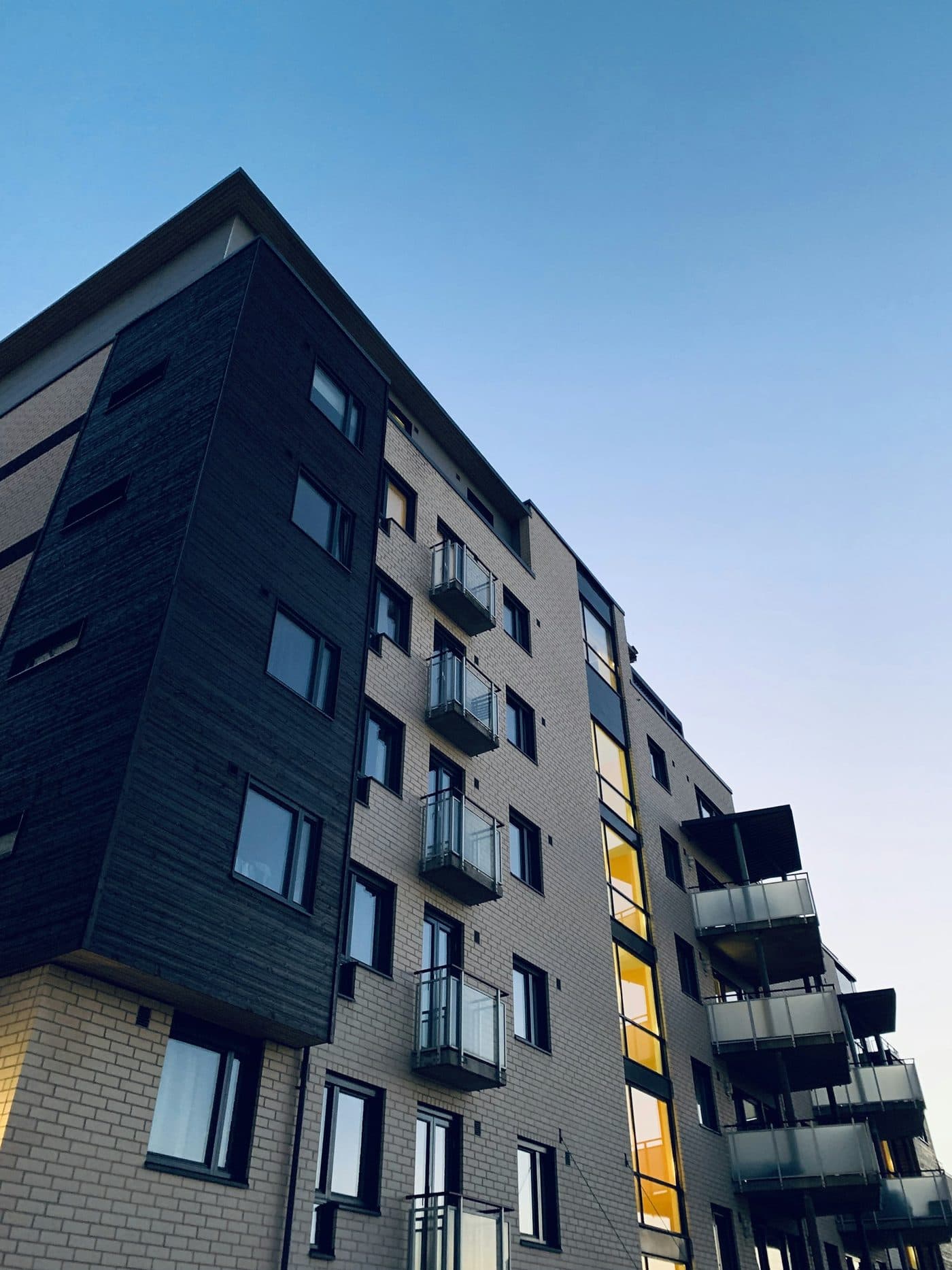 A modern apartment building representing the communities MGMT Tracker helps manage